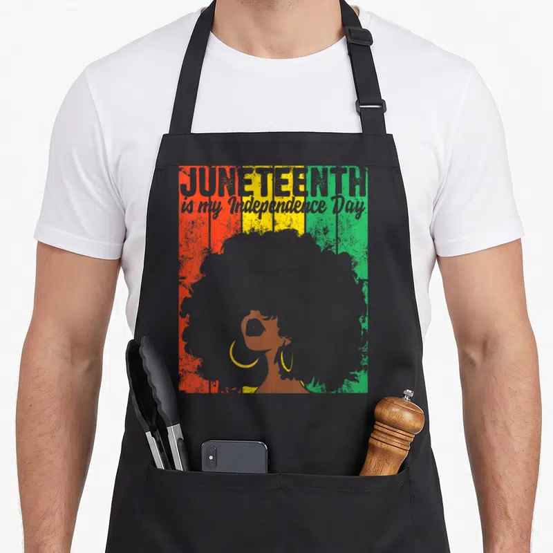 Slavery independence apron - Retro woman silhouette with afro against red yellow green stripes and grey text — shown on a black cotton canvas apron against a white background