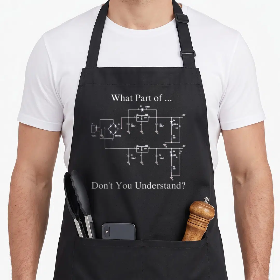 Electrical engineer apron - White circuit diagram with component labels and sarcastic text on black background — shown on a black cotton canvas apron against a white background