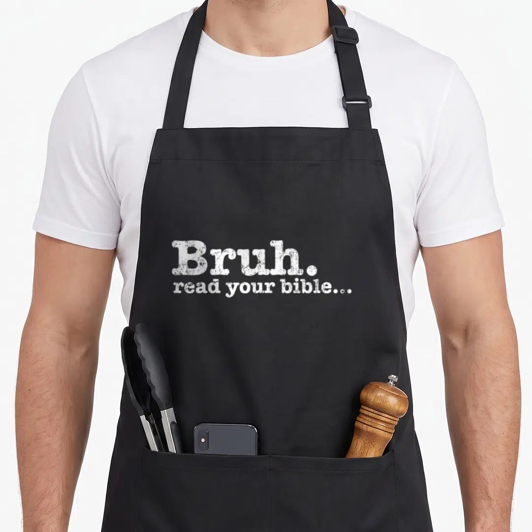 Meme funny christian aprons - White stacked text reading Bruh read your bible on black fabric — shown on a black cotton canvas apron against a white background