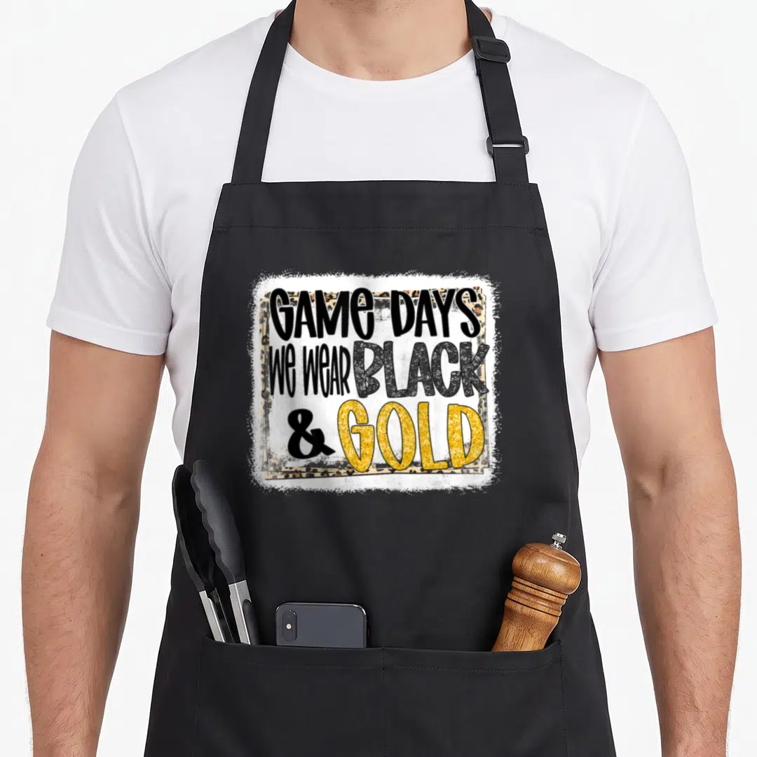 Gameday football apron - Black and gold text over leopard print rectangle with distressed white border — shown on a black cotton canvas apron against a white background