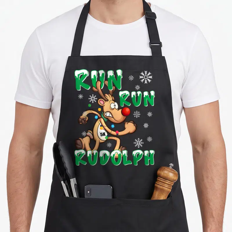 Run holiday christmas aprons - Cartoon reindeer running with 5K bib and Christmas lights surrounded by green RUN RUN — shown on a black cotton canvas apron against a white background