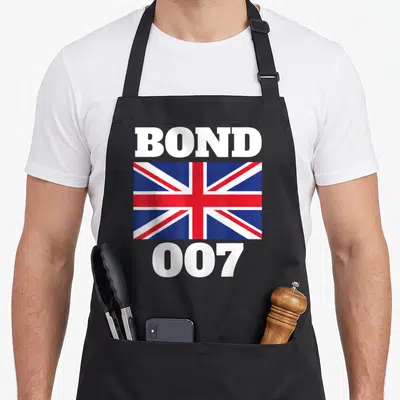 Bond union aprons - BOND 007 text framing a Union Jack flag in white red and blue — shown on a black cotton canvas apron against a white background