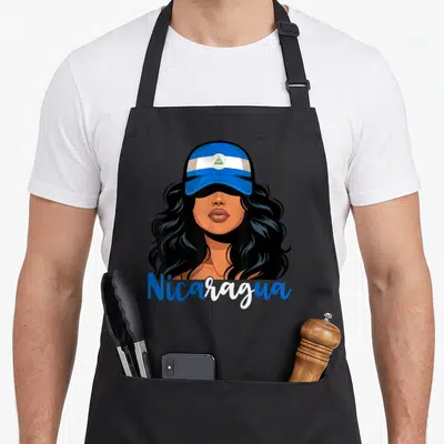 Nicarag nicaraguan girl apron - Cartoon woman in blue cap with Nicaragua text on black apron — shown on a black cotton canvas apron against a white background