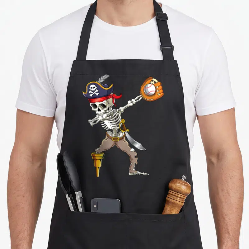 Dab skeleton apron - Cartoon skeleton pirate dabbing with baseball glove and gold peg leg — shown on a black cotton canvas apron against a white background