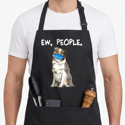 Face australian aprons - cartoon dog in blue mask with arched ew people text — shown on a black cotton canvas apron against a white background