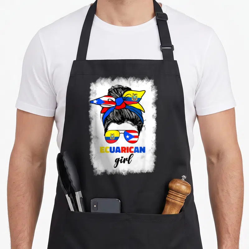 Ecuadorian rican pride apron - Ecuarican girl with flag sunglasses and messy bun in yellow blue red black white — shown on a black cotton canvas apron against a white background