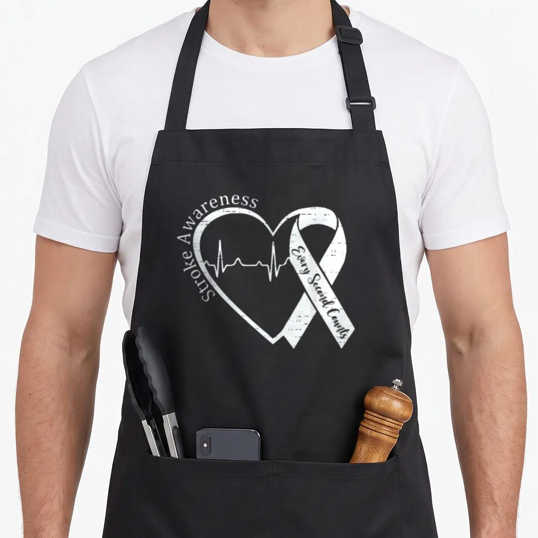 Brain stroke awareness apron - White heart outline with heartbeat line and awareness ribbon reading Stroke Awareness — shown on a black cotton canvas apron against a white background