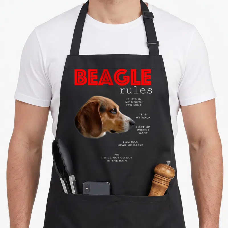 Rule beagle apron - Photo beagle head with red BEAGLE title and white rule list text — shown on a black cotton canvas apron against a white background