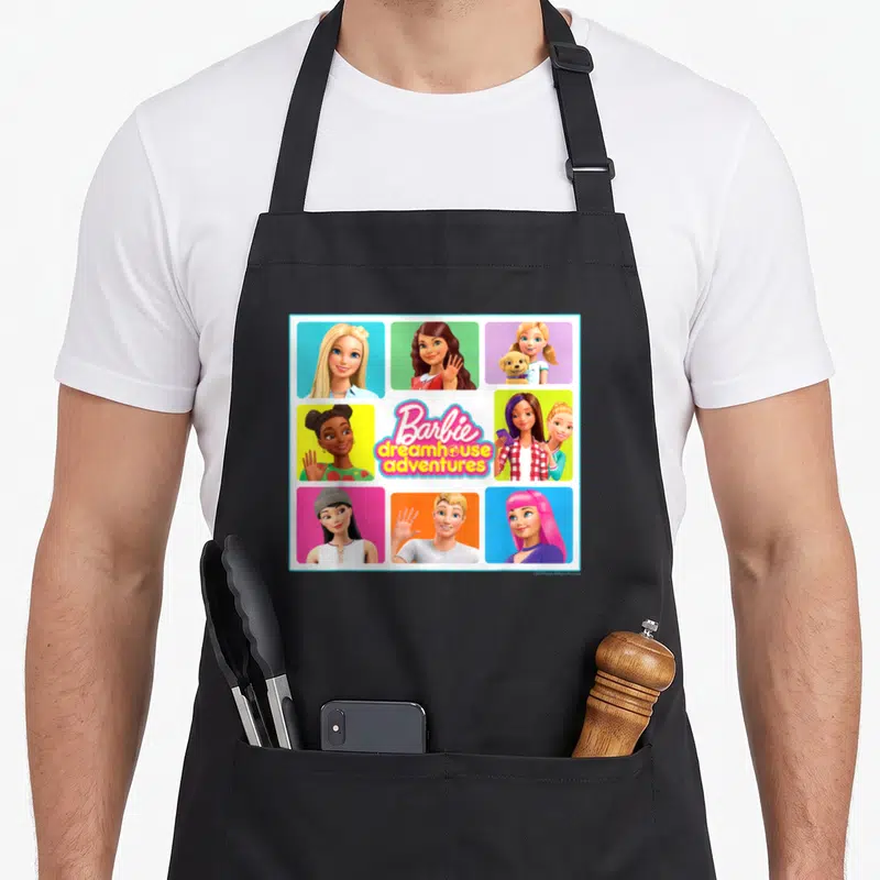 Dreamhouse square apron - Barbie dreamhouse adventures logo surrounded by grid of cartoon character portraits in pink — shown on a black cotton canvas apron against a white background