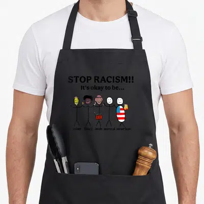 Racism asian apron - Five stick figures holding hands labeled asian black arab normal american under Stop Racism text — shown on a black cotton canvas apron against a white background