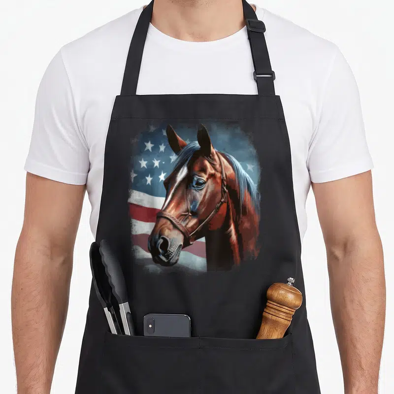 Horseback american flag apron - Realistic brown horse head overlapping a stylized red white and blue American flag — shown on a black cotton canvas apron against a white background