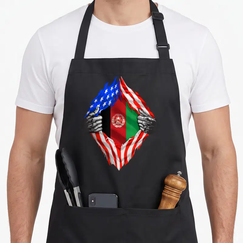 Afghan american flag apron - Two grey hands rip open USA flag to reveal Afghanistan flag with blue red white black — shown on a black cotton canvas apron against a white background