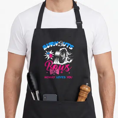 Announcement bow apron - Car wheel smoke and pink bow print with BURNOUTS OR Bows text — shown on a black cotton canvas apron against a white background
