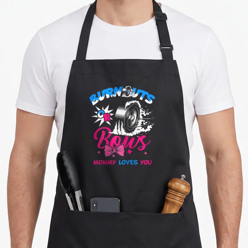 Announcement bow apron - Car wheel smoke and pink bow print with BURNOUTS OR Bows text — shown on a black cotton canvas apron against a white background