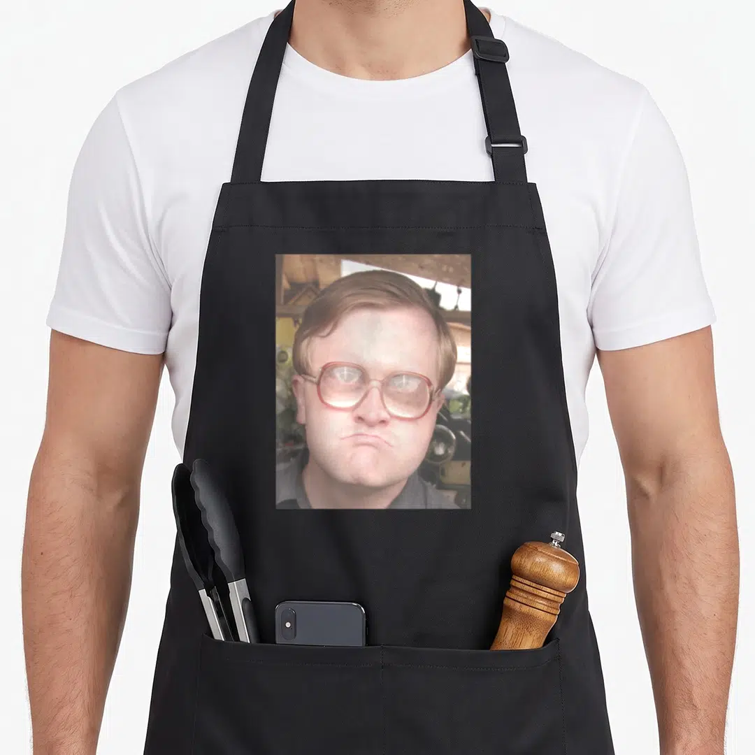 Portrait trailer apron - Photo of man with glasses in beige red grey tones — shown on a black cotton canvas apron against a white background