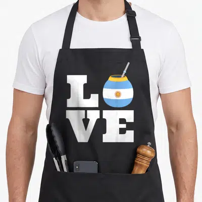 Yerba pride apron - LOVE text with striped mate gourd replacing the O letter — shown on a black cotton canvas apron against a white background