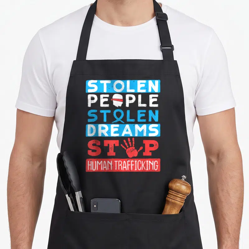 National modern apron - Stolen People Stolen Dreams Stop Human Trafficking text with blindhead ribbon handprint symbols — shown on a black cotton canvas apron against a white background