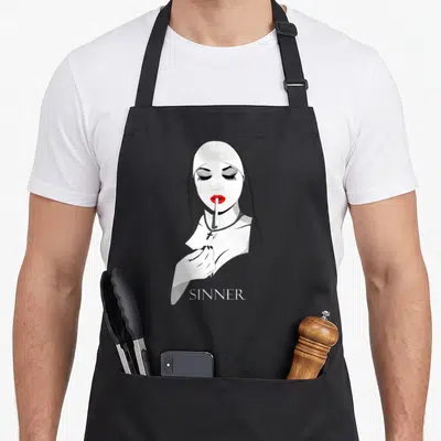 Sinner master apron - Stylized nun smoking cigarette with red lips and SINNER text in white, red, and black — shown on a black cotton canvas apron against a white background