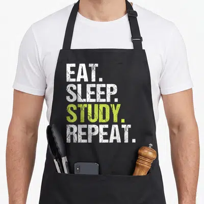 Sleep christmas apron - EAT SLEEP STUDY REPEAT text in white and lime green distressed font — shown on a black cotton canvas apron against a white background