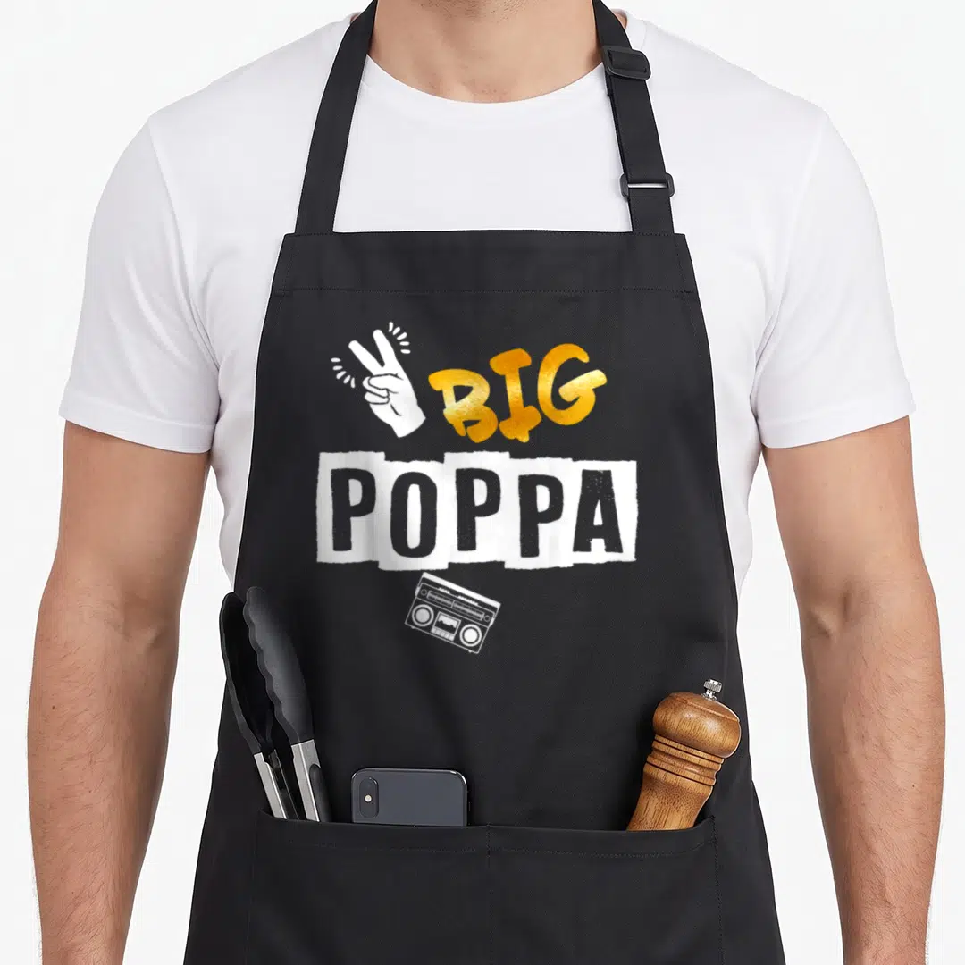 Hop 2nd apron - Gold BIG POPPA text with white peace sign hand and boombox graphic — shown on a black cotton canvas apron against a white background