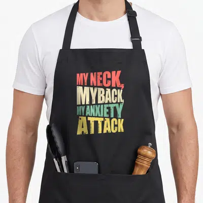 Anxiety anxious apron - Stacked text MY NECK MY BACK MY ANXIETY ATTACK in red beige green yellow — shown on a black cotton canvas apron against a white background