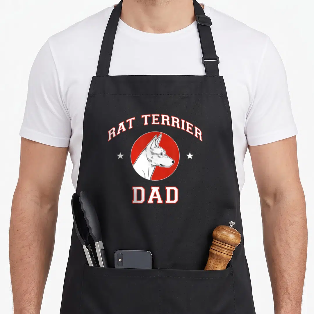 Terrier father dog apron - Rat Terrier Dad text over red circle with dog head and two white stars — shown on a black cotton canvas apron against a white background