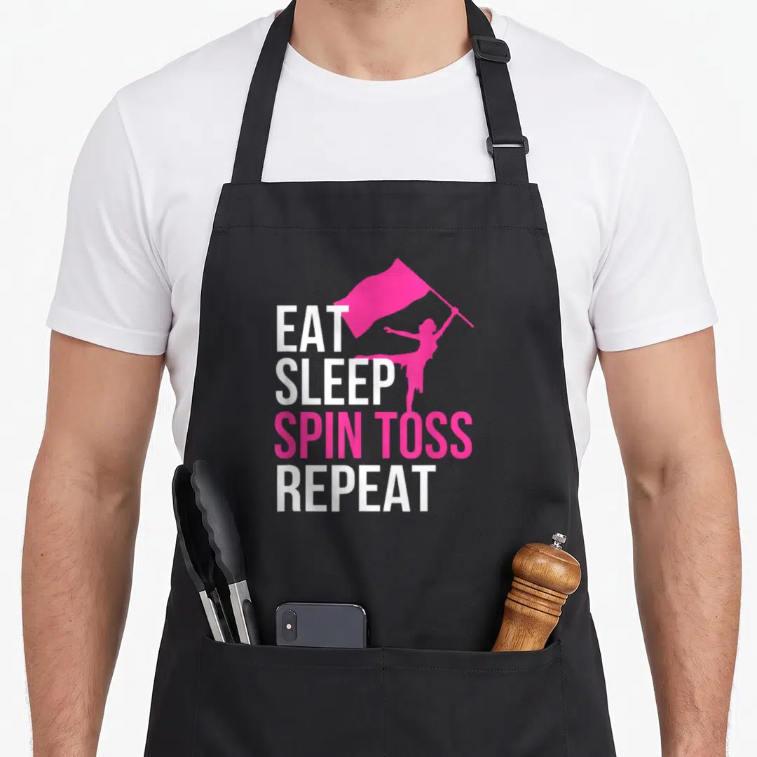 Eat color guard apron - Stacked EAT SLEEP SPIN TOSS REPEAT text with pink flag bearer silhouette — shown on a black cotton canvas apron against a white background