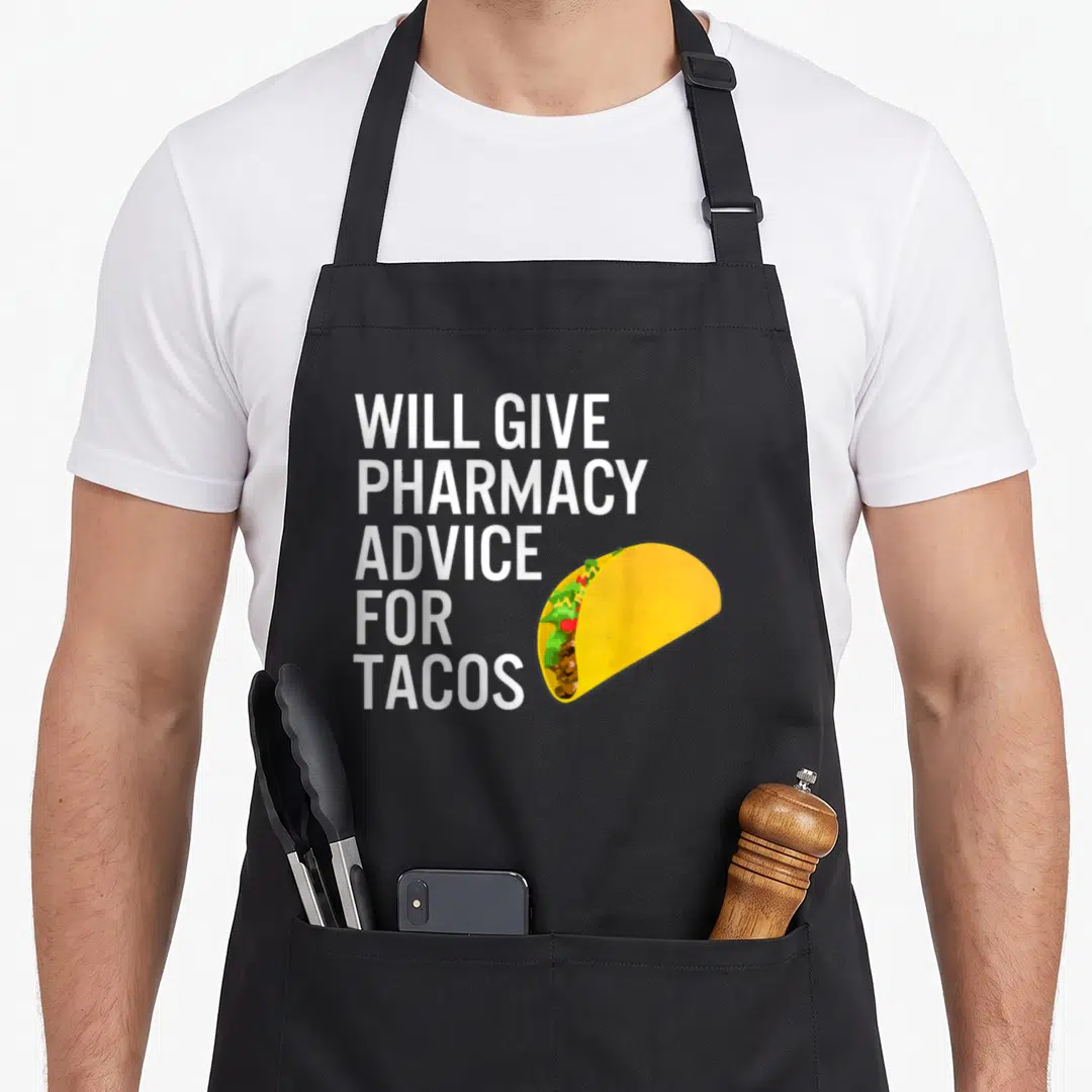 Advice pharmacist apron - Will Give Pharmacy Advice For Tacos text next to a cartoon taco with yellow shell and brown — shown on a black cotton canvas apron against a white background