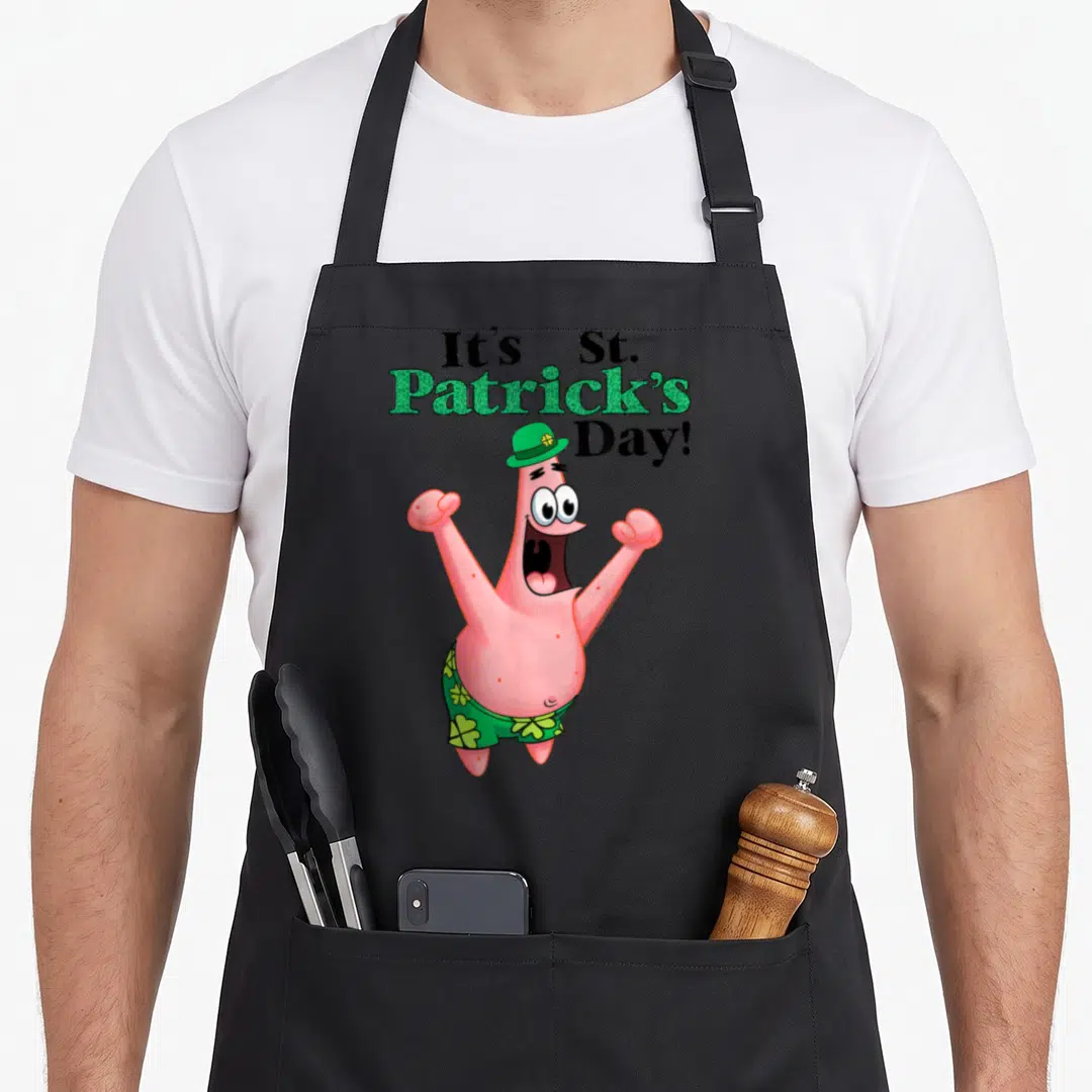 Funny st patrick day aprons - Patrick Star in green hat and shorts below It's St Patrick's Day text — shown on a black cotton canvas apron against a white background