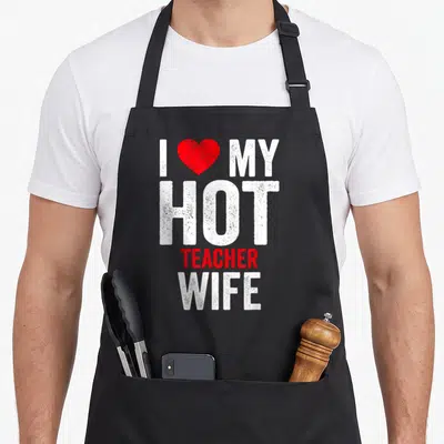 Hot best teacher apron - I love my hot teacher wife text with red heart and distressed white font — shown on a black cotton canvas apron against a white background