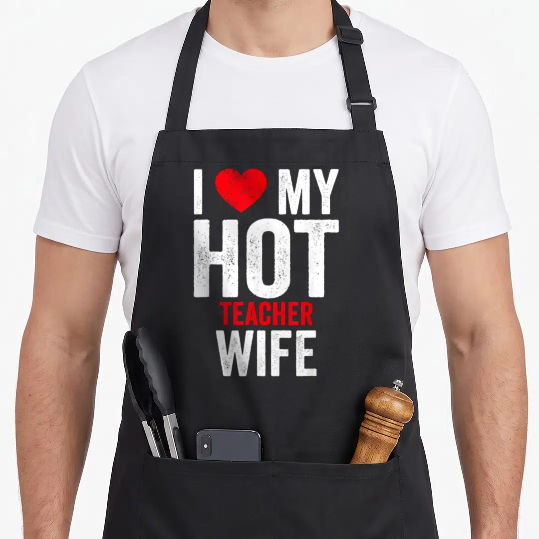 Hot best teacher apron - I love my hot teacher wife text with red heart and distressed white font — shown on a black cotton canvas apron against a white background