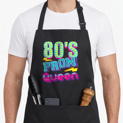Throwback queen apron - Stacked 80s Prom Queen text with yellow lightning bolts in blue pink yellow and purple — shown on a black cotton canvas apron against a white background
