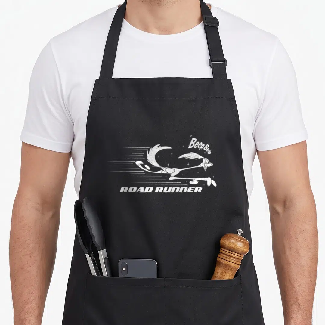 Fast road apron - Distressed white Road Runner running right with Beep Beep text — shown on a black cotton canvas apron against a white background