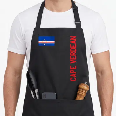Flag root cape verde apron - Cape Verde flag and vertical red CAPE VERDEAN text on black background — shown on a black cotton canvas apron against a white background