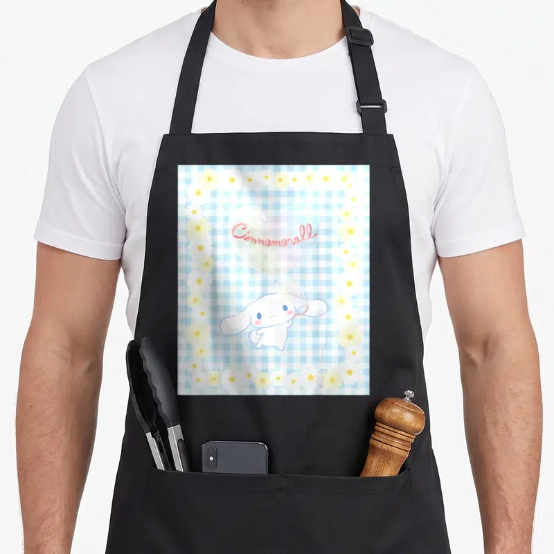Bubble cinnamoroll apron - Cinnamoroll character with wand under text bubble on blue gingham with daisy border — shown on a black cotton canvas apron against a white background