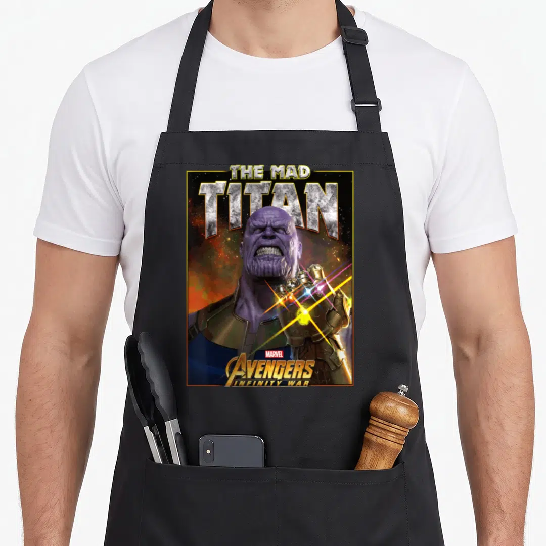Infinity bling aprons - Thanos The Mad Titan Avengers Infinity War poster style design with purple and gold colors — shown on a black cotton canvas apron against a white background