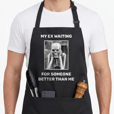 Divorced husband wife aprons - Framed skeleton photo with text MY EX WAITING FOR SOMEONE BETTER THAN ME — shown on a black cotton canvas apron against a white background