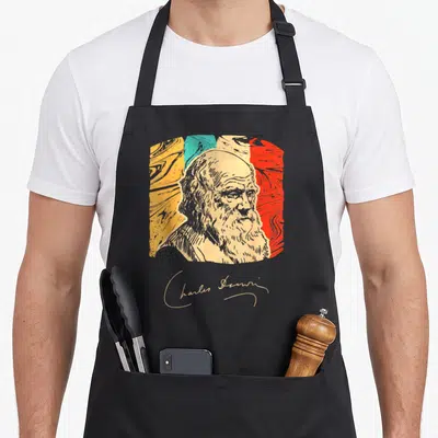Naturalist charles apron - Line art portrait of Charles Darwin over marbled beige yellow teal red background — shown on a black cotton canvas apron against a white background