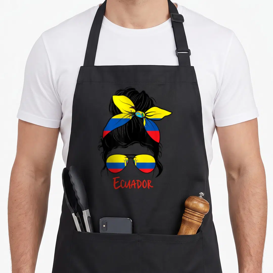 Ecuador ecuadorian apron - Cartoon woman head with bun, flag sunglasses, and red ECUADOR text — shown on a black cotton canvas apron against a white background