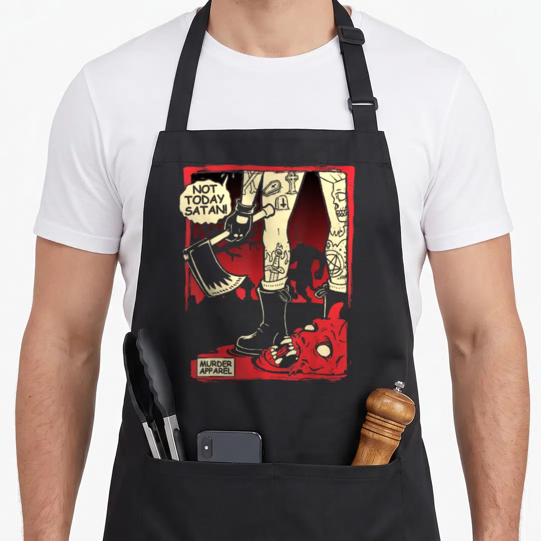 Today goth apron - Tattooed legs holding axe over severed head with text NOT TODAY SATAN! — shown on a black cotton canvas apron against a white background