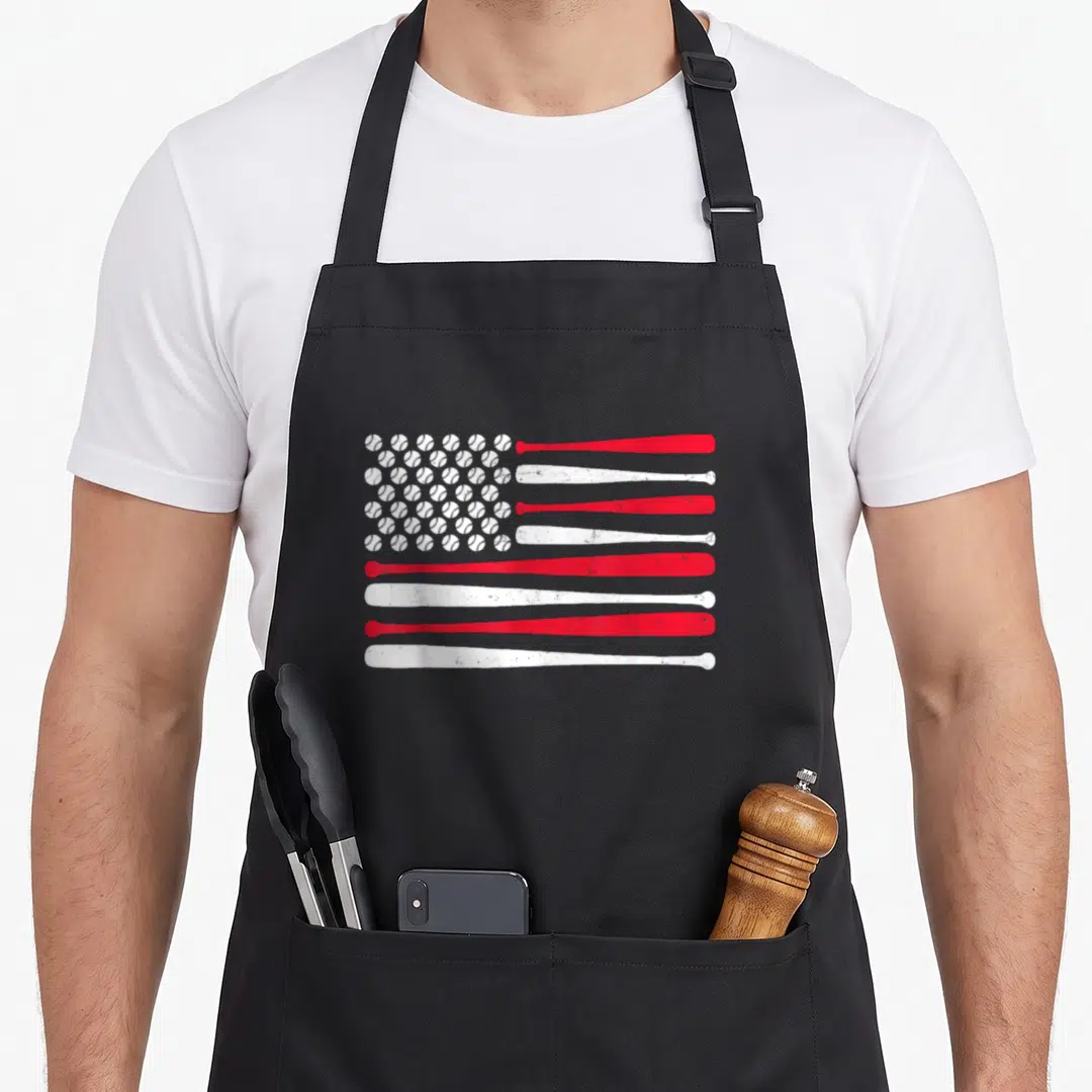 Baseball sport american flag apron - Red and white flag pattern made of baseball bats and balls with distressed texture — shown on a black cotton canvas apron against a white background