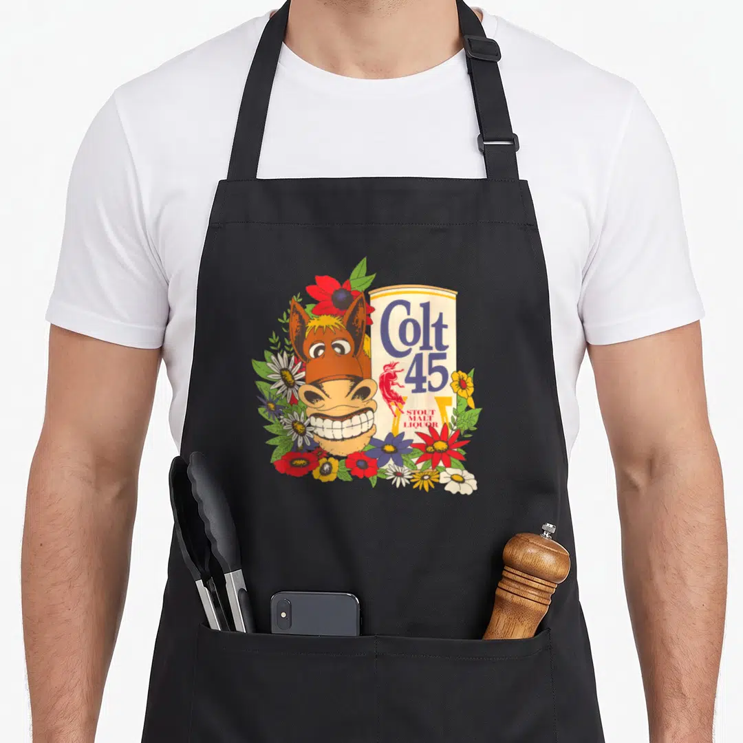 Colt floral apron - Cartoon horse head next to Colt 45 bottle label surrounded by red blue green yellow and brown — shown on a black cotton canvas apron against a white background
