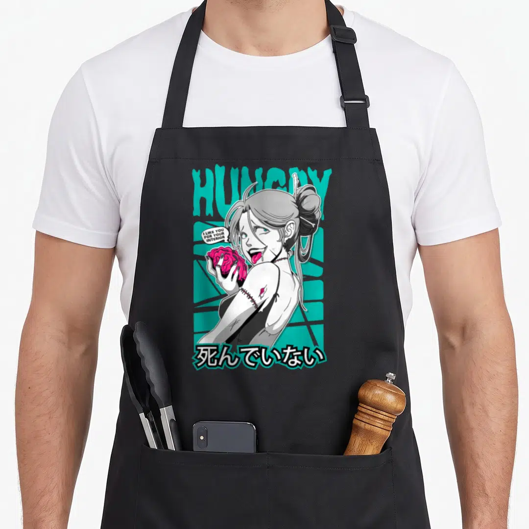 Ecchi anime apron - Zombie girl holding pink brain with HUNGRY text and Japanese characters — shown on a black cotton canvas apron against a white background