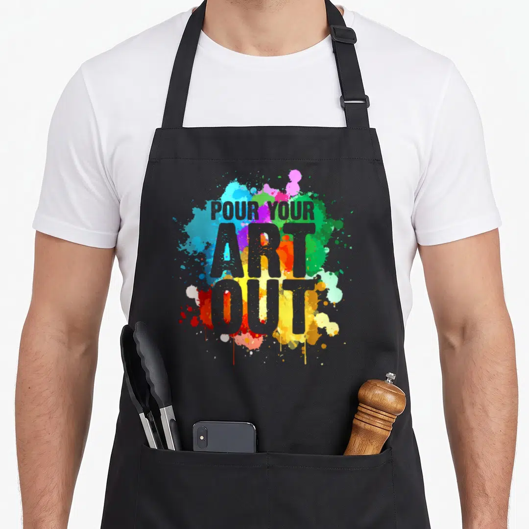 Artist paint painter apron - Grey text POUR YOUR ART OUT over blue, purple, green, yellow, red, and grey watercolor — shown on a black cotton canvas apron against a white background