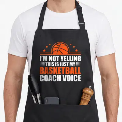 Coaching basketball coach apron - Orange basketball and stars above text I'M NOT YELLING THIS IS JUST MY BASKETBALL — shown on a black cotton canvas apron against a white background