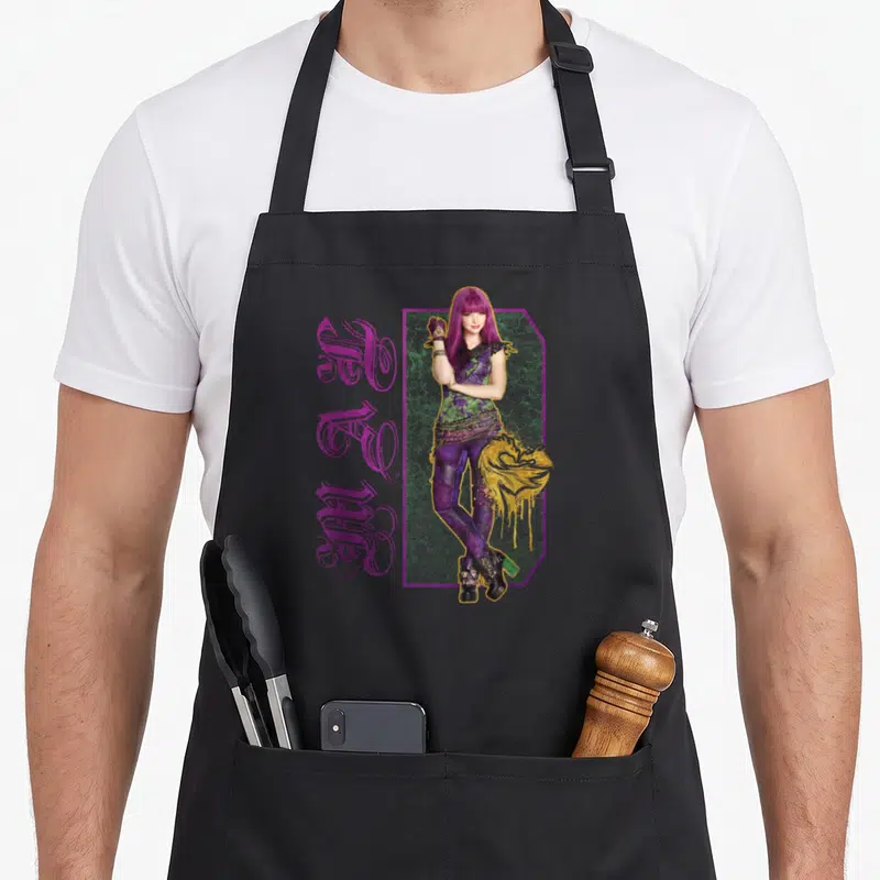 Descendant paint apron - Purple haired woman standing next to vertical MAGIC text with gold drip accents — shown on a black cotton canvas apron against a white background