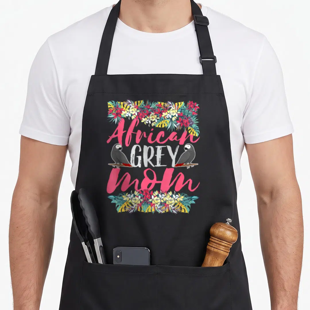 Mother african aprons - Two parrots flanking stacked text African GREY Mom surrounded by pink and yellow floral borders — shown on a black cotton canvas apron against a white background
