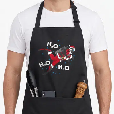 Diving class funny apron - Santa swimming diagonally with three H2O texts and blue bubbles in red white blue grey — shown on a black cotton canvas apron against a white background