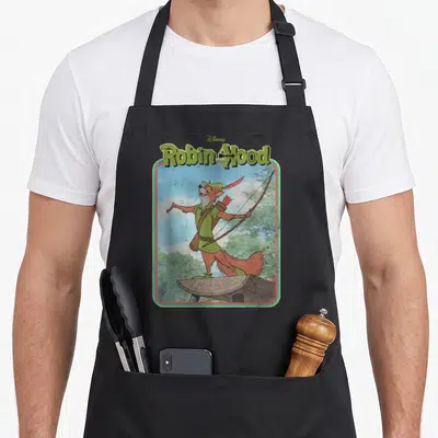 Hood robin mom apron - Fox archer in green tunic standing on log under Robin Hood title with forest background — shown on a black cotton canvas apron against a white background