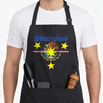 Filipino mexican apron - Cartoon Mexipino eagle perched on cactus with sun, three stars, and blue gothic text — shown on a black cotton canvas apron against a white background